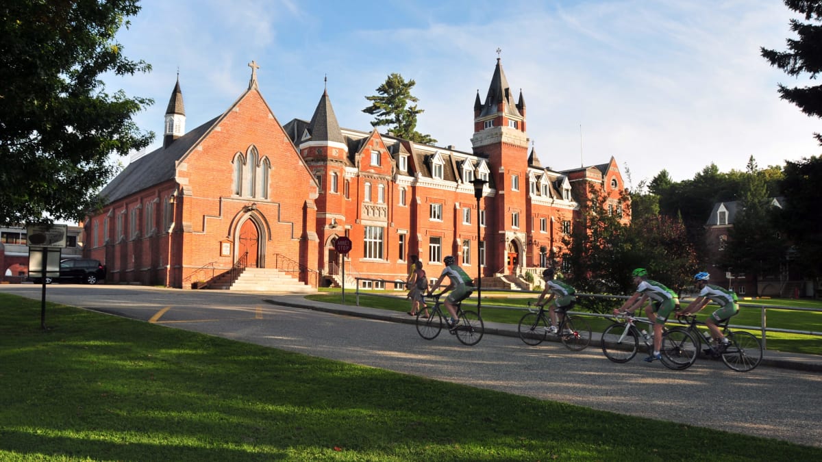 A group of cyclists in front of Bishop's University.