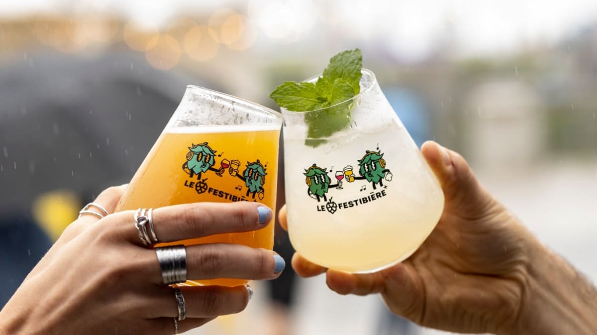 Close-up of two hands holding beer glasses featuring the Festibière logo.