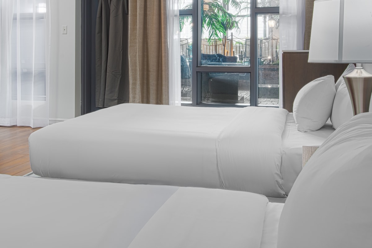 Hôtel Universel Québec - White bedroom with two beds.
