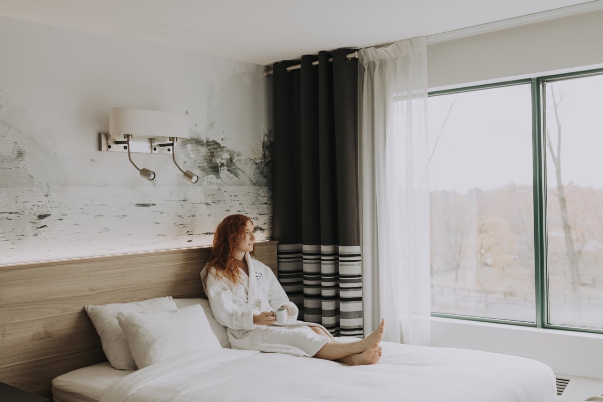 Woman in a bed at Château Joliette.