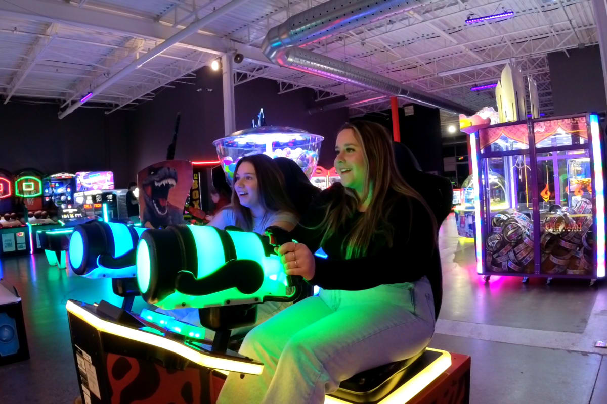 Two women playing arcades.