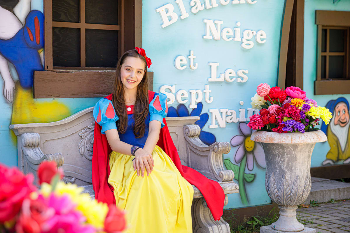 Snow White in front of her house