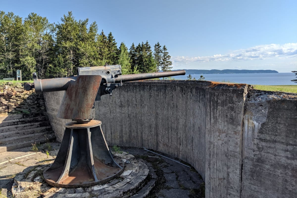 An old military cannon located near a bay.
