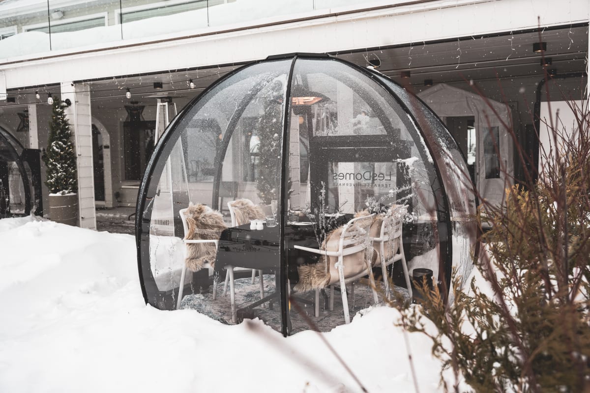 Table in a clear dome in winter at Bistro Koz.