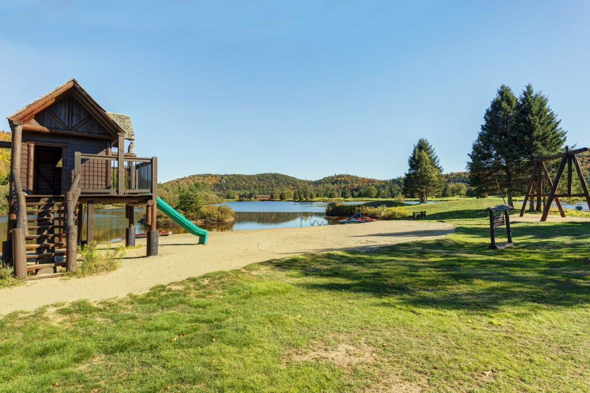 Children's playground by the lake at Chalets Royal Laurentien.