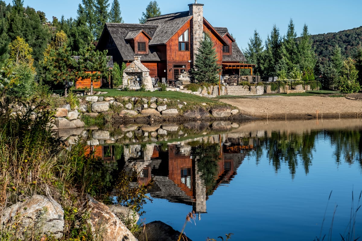 Exterior of a large wood-and-stone house at Chalets Royal Laurentien.