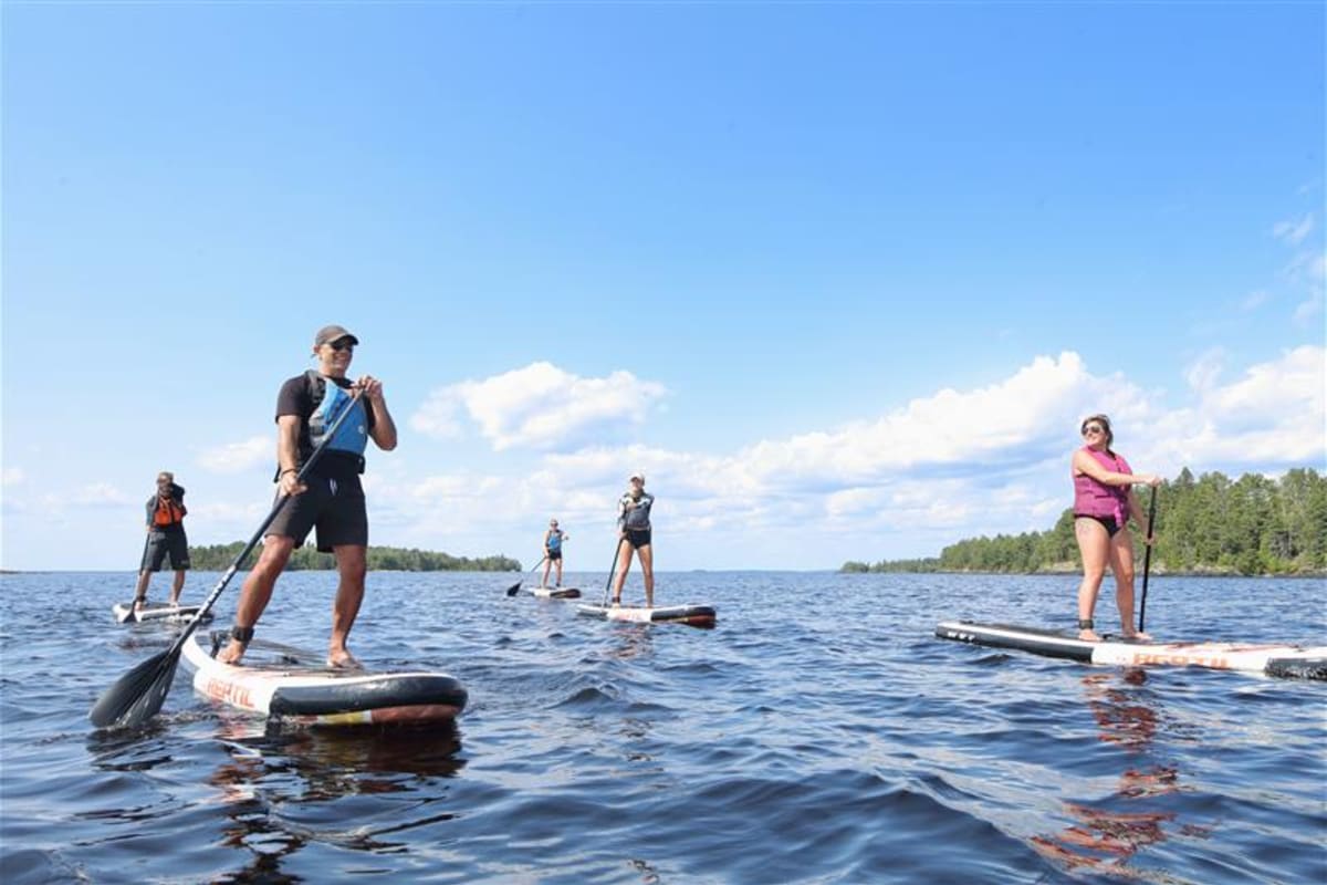 Group of people on stand-up paddleboards.