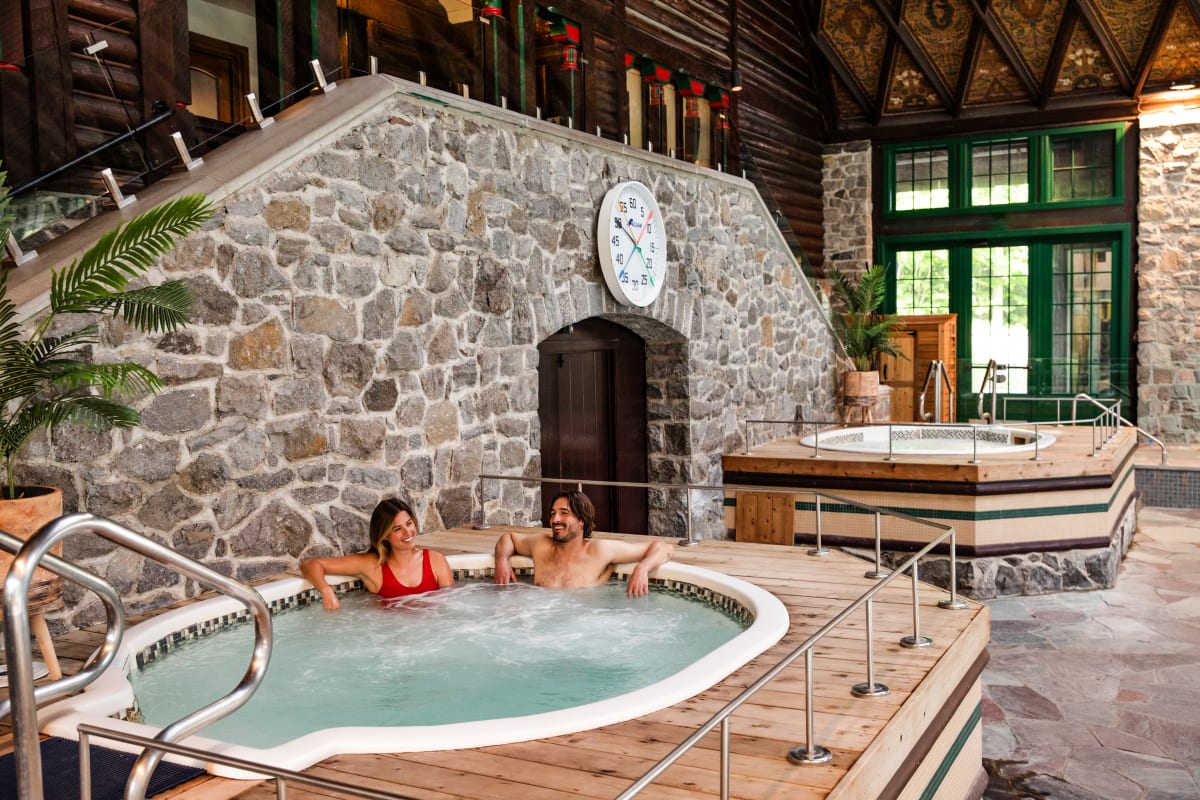 Couple in a hot tub at Fairmont Le Château Montebello