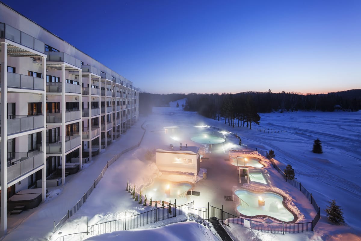 Nordic spa at Estérel Resort on a winter evening.