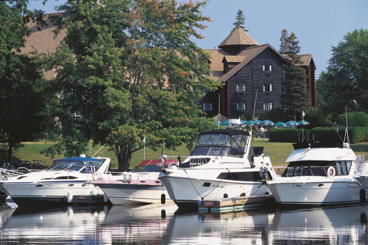 Boats at the marina with Fairmont Le Château Montebello in the background