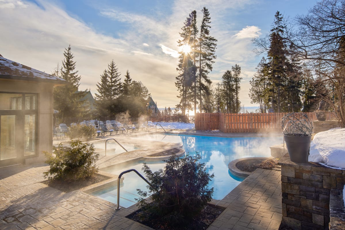 Outdoor heated pool in winter at Fairmont Le Manoir Richelieu.