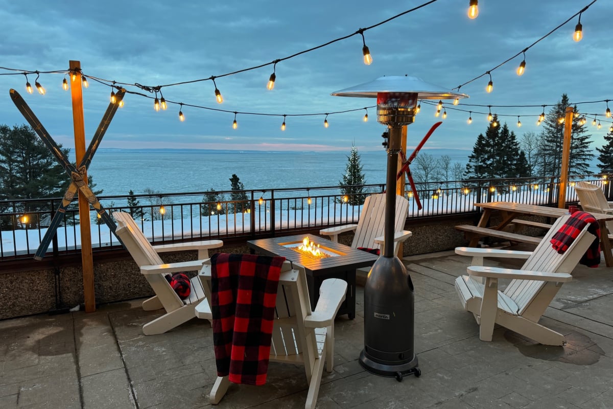 Winter terrace at Manoir Richelieu, with chairs, blankets and outdoor fireplace.
