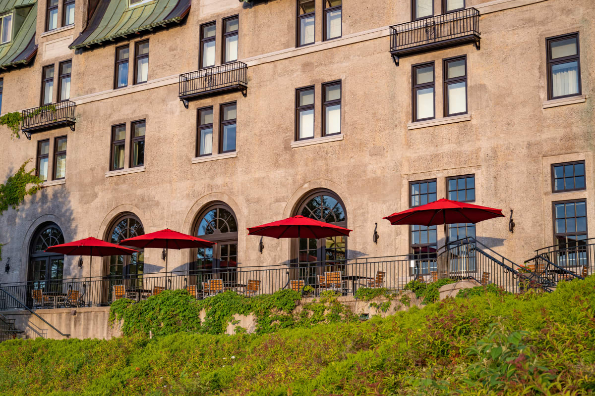 Terrace with several red umbrellas at the Fairmont Le Manoir Richelieu.