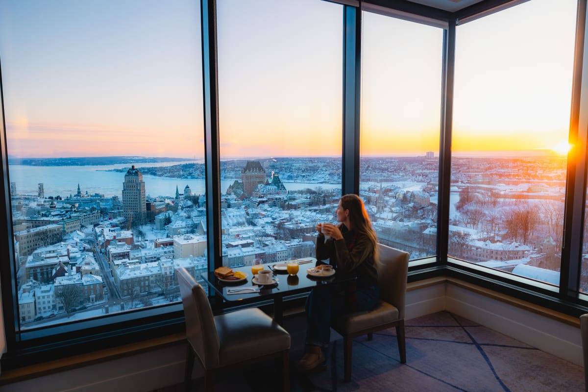 A woman working in front of windows.