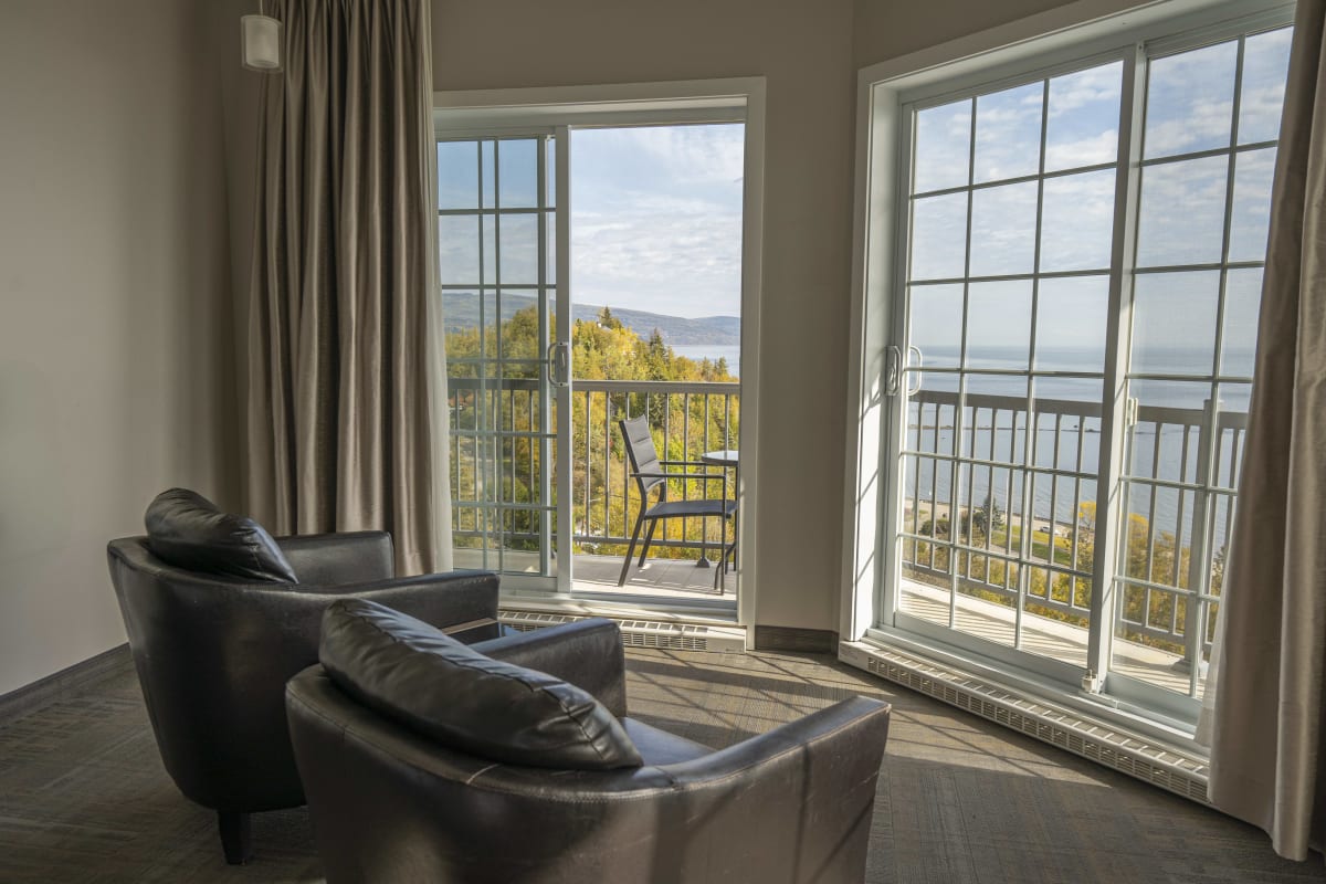 A view of the river in the fall from a room inside the building.