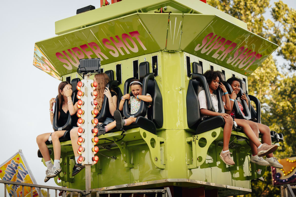 Kids in an amusement park ride at Fête du Lac des Nations.