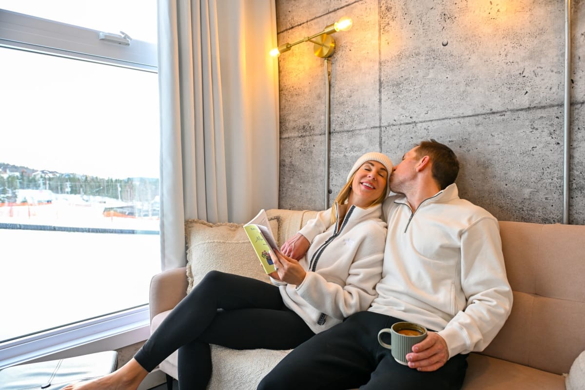 Smiling couple inside a Coolbox accommodation at Mont Grand-Fonds.