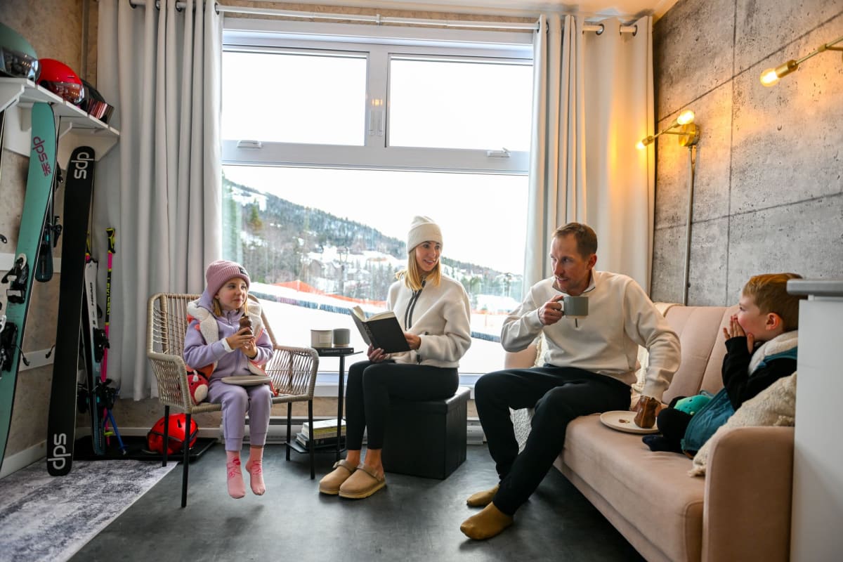 Family inside a Coolbox accommodation at Mont Grand-Fonds.