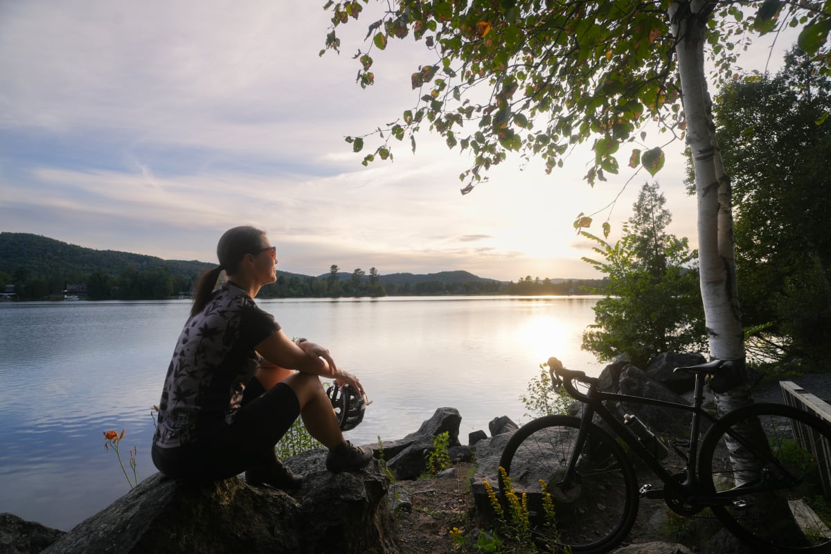Cyclist taking a break on the P'tit train du Nord linear park.