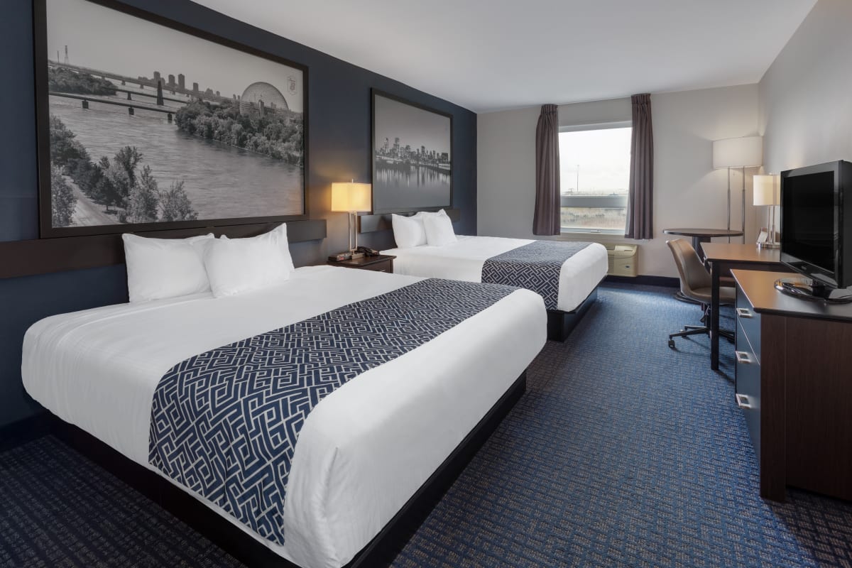 Interior of a two-bed room decorated in shades of gray.