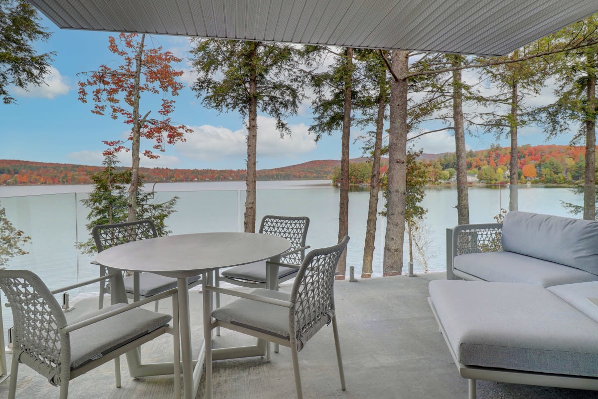 An outdoor living area by the lake in the fall.