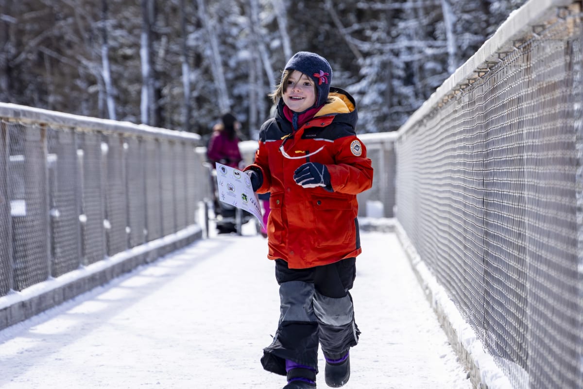 Child taking a quiz at the Sentier des Cimes. 