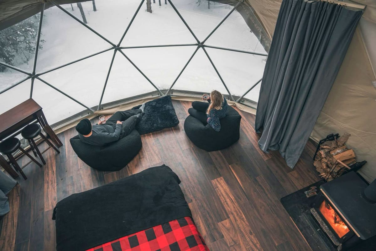 Couple à l'intérieur d'un hébergement de type dôme.