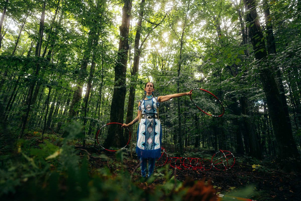 Indigenous dancer in a forest.