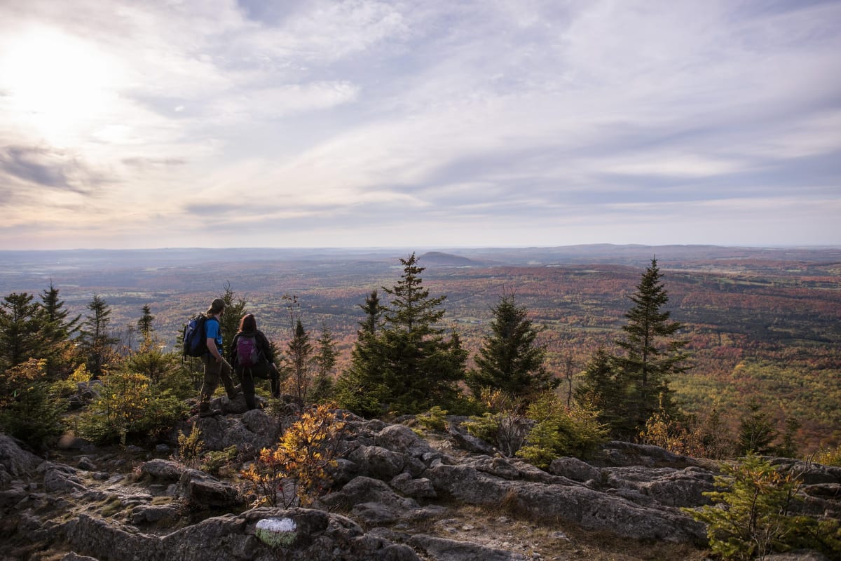 Two people on a hike in the fall in Quebec.