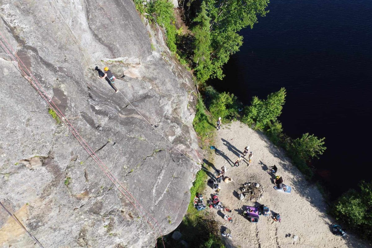 Bird's-eye view of a group of climbers at the foot of a rock face