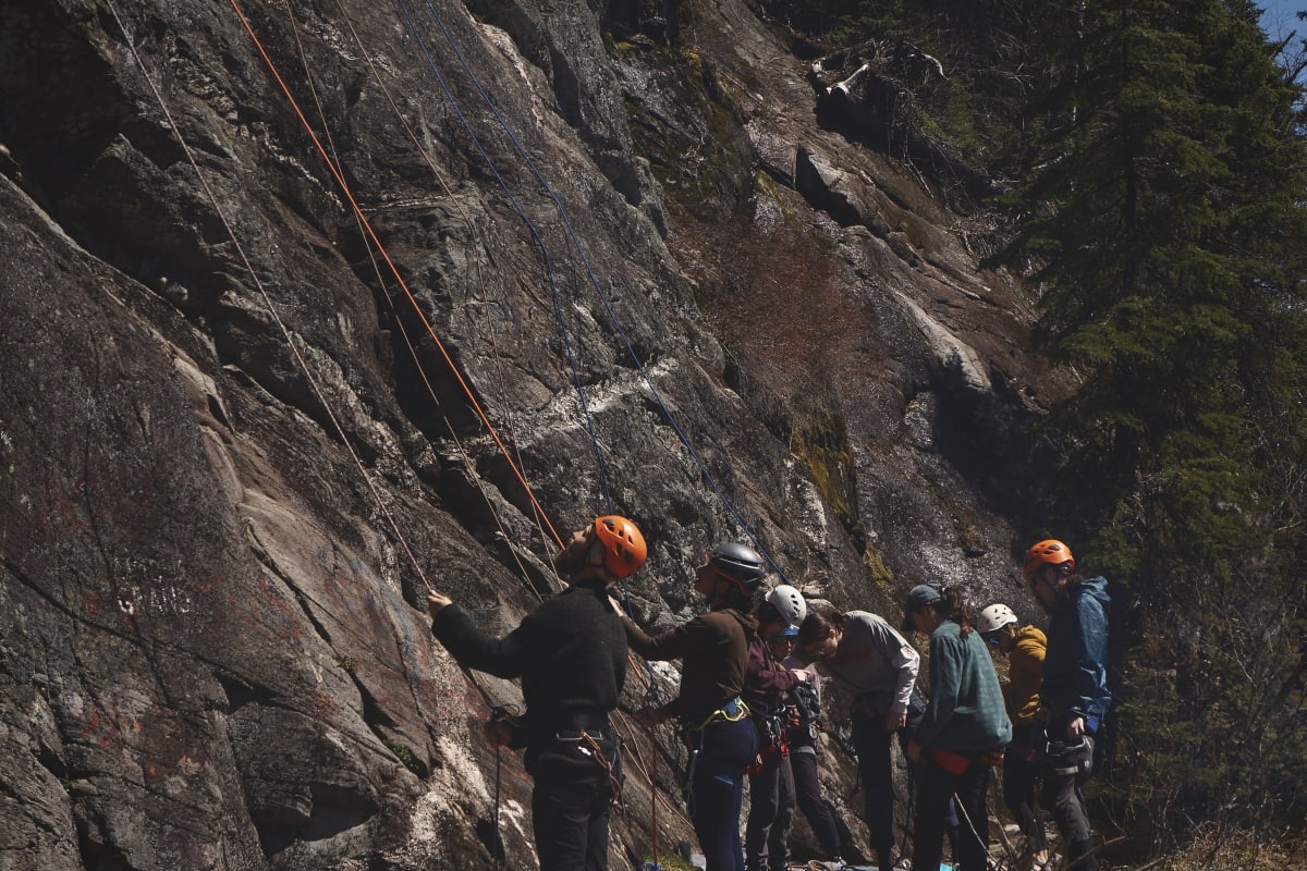 Group of climbers at the bottom of a rock face