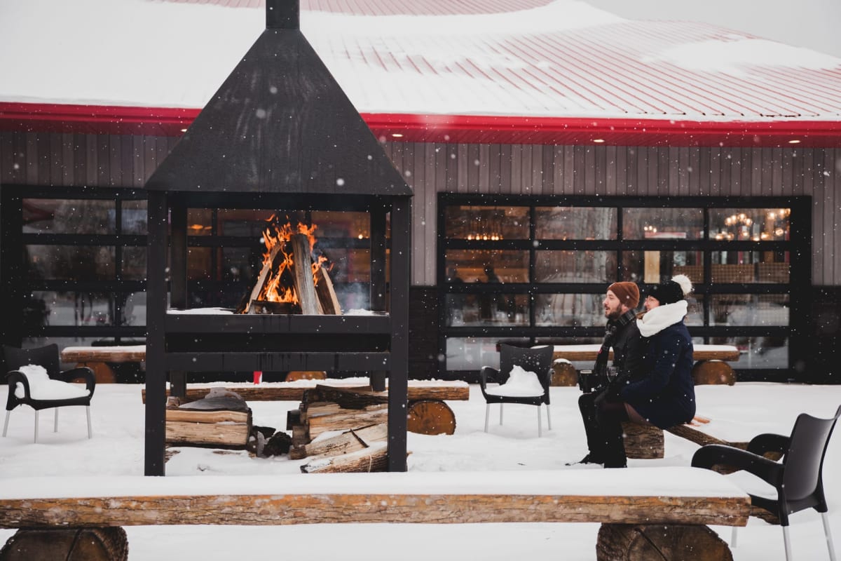 Couple and outdoor fire in front of the Entêté microbrewery.