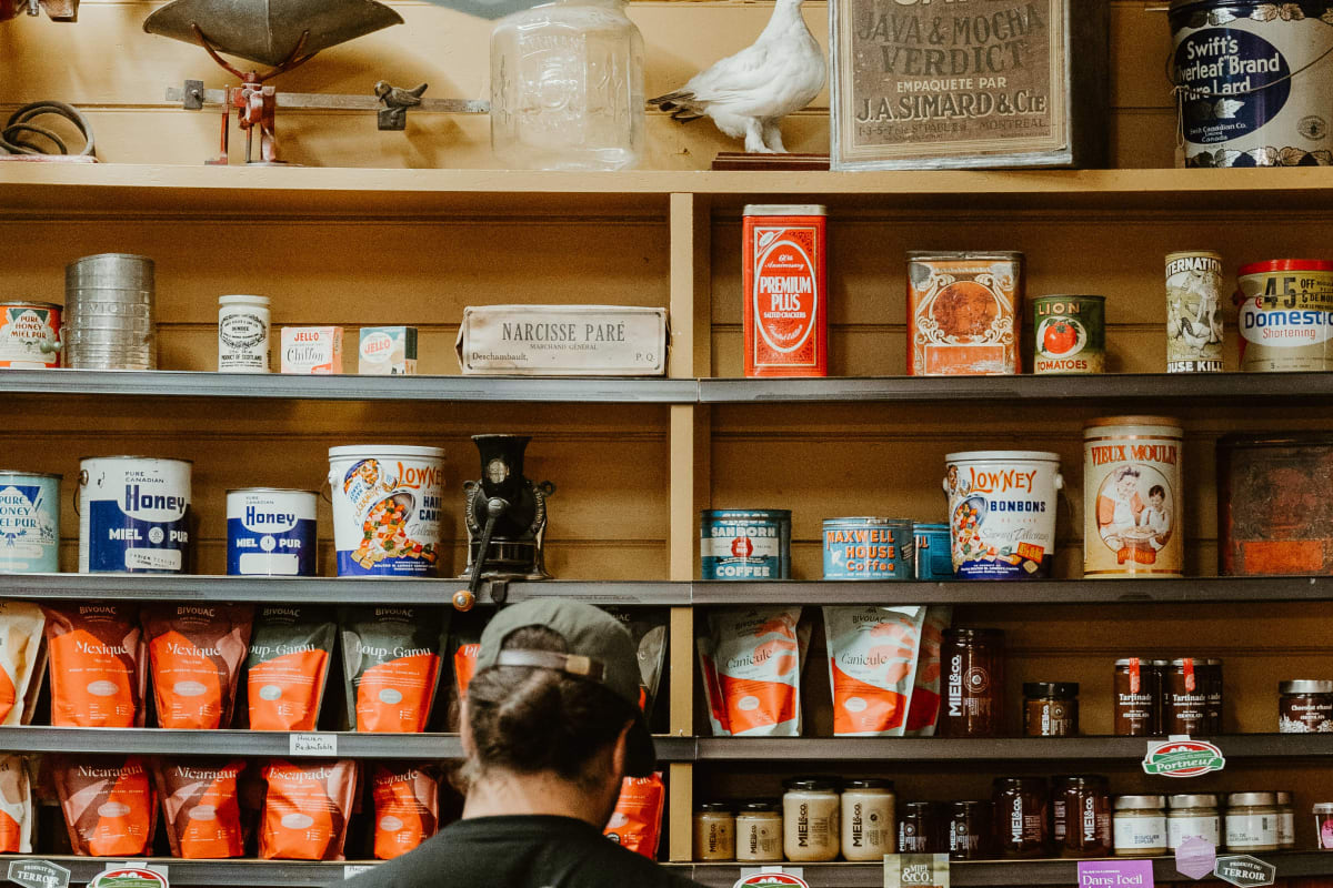 Man in front of a display of local products in a store.