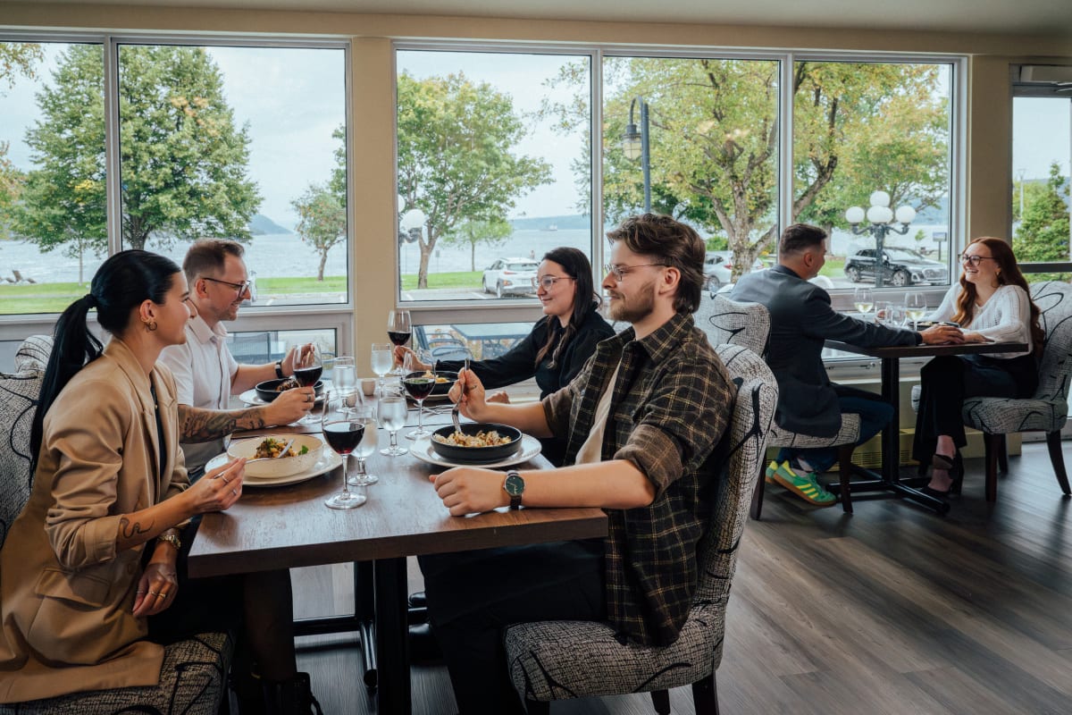 Four people enjoying a gourmet meal at Auberge des 21.