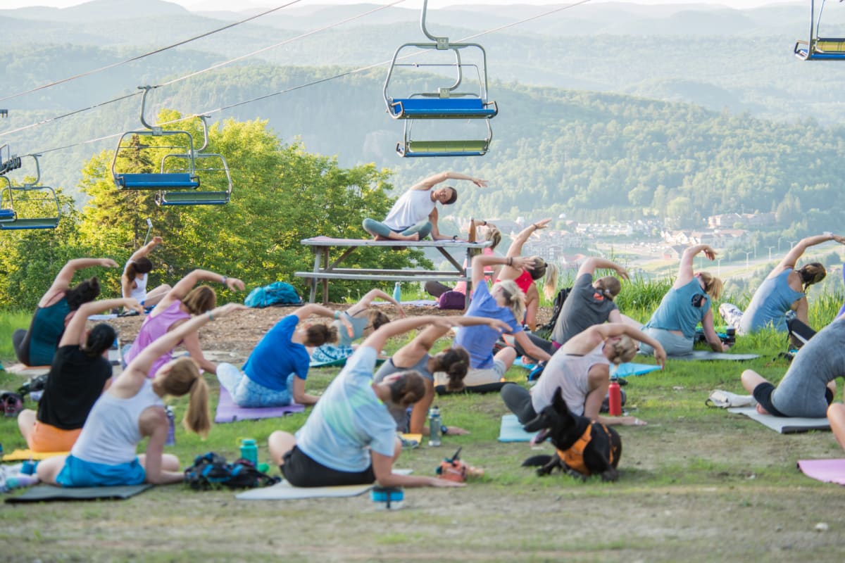 Group of people doing yoga on a mountain