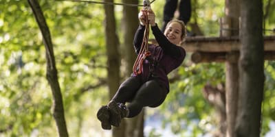 Teenage girl zip-lining