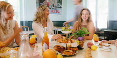 La Midinette - Women sitting at a table filled with pastries and fruit