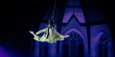 Le Monastère - Cabaret de Cirque - A suspended artist with their head in a disco ball