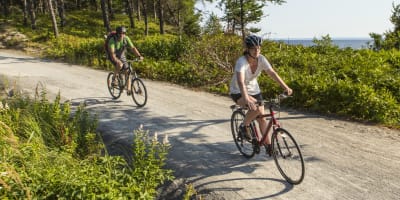 Parc national de la Pointe-Taillon - A man and a woman cycling in nature