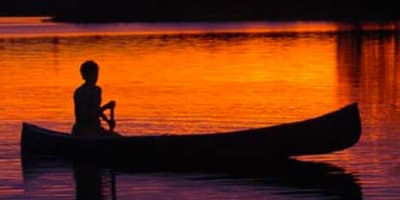 Fishing in a canoe at sunrise