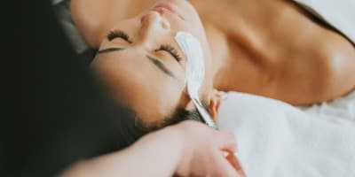 Woman receiving a facial treatment