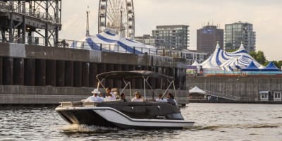  A group of people are taking a boat tour on the St. Lawrence River in Montreal's Old Port, with a private captain.