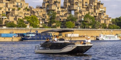 Friends are sailing on the St. Lawrence River in Montreal's Old Port with an experienced captain.