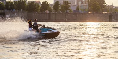 A couple takes a jet ski ride on the St. Lawrence River from the Old Port of Montreal.