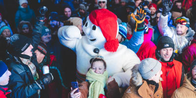 Québec Winter Carnival - Bonhomme Carnaval in a crowd outside