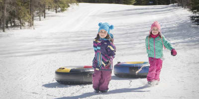 Two girls sliding down a tube at Les Sources Joyeuses..