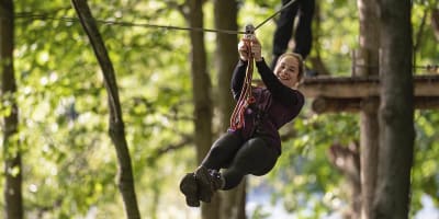 Teenage girl zip-lining