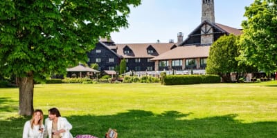 Two people sharing a picnic in a garden.