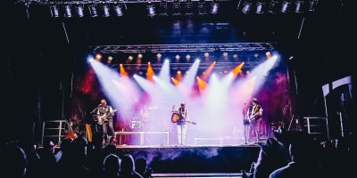 Festival Les Grandes Veillées - Artists performing on a stage lit up with lights