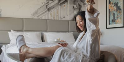 A woman in a hotel room.